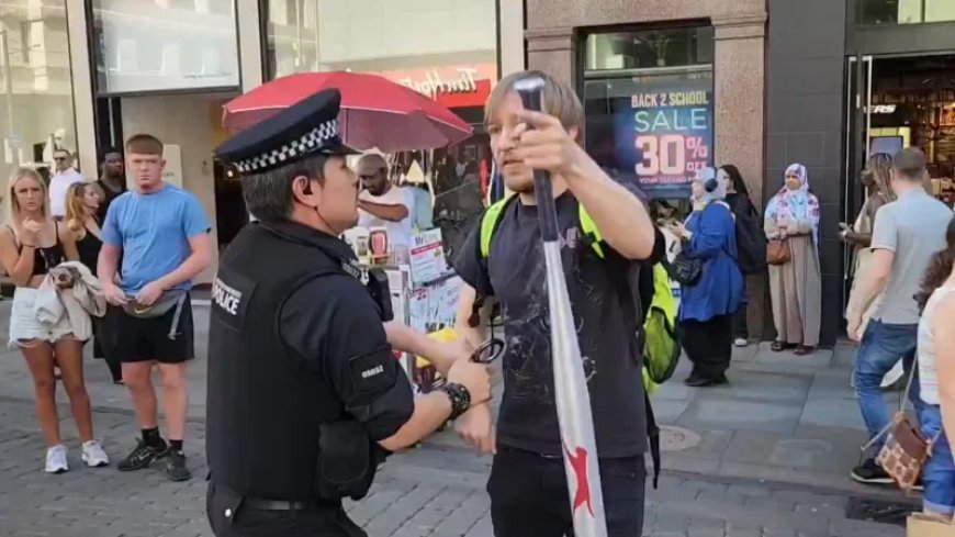 Watch: UK Police Officer Assaults Man Walking Out Of Shop With Wrapped Baseball Bat